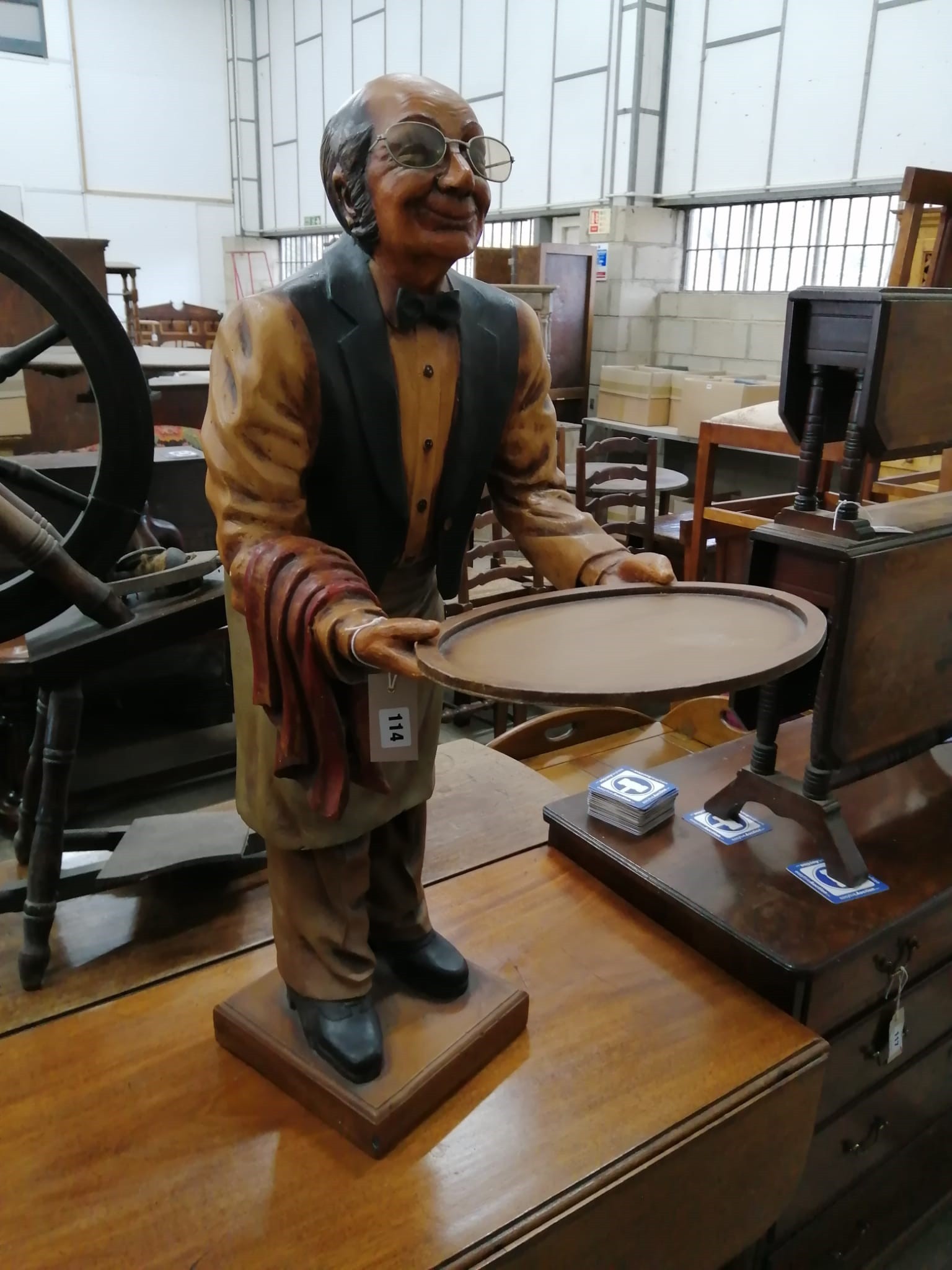 A painted composition dumb waiter in the form of an elderly butler, width 34cm, height 95cm